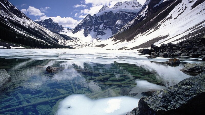 frozen lake in snowy mountains