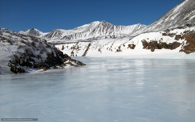 frozen lake in snowy mountains