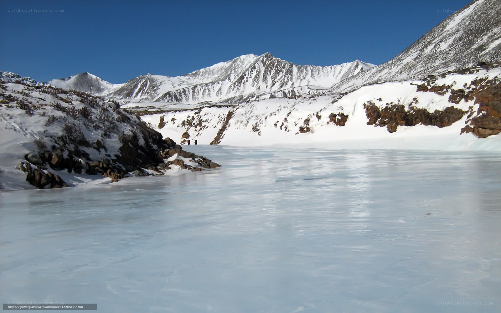 frozen lake in snowy mountains