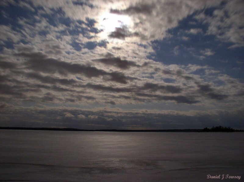 frozen lake under cloudy sky