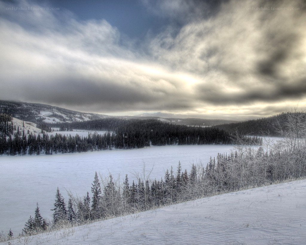 frozen lake under cloudy sky