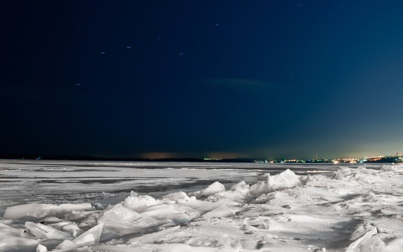 Frozen lake under starry night