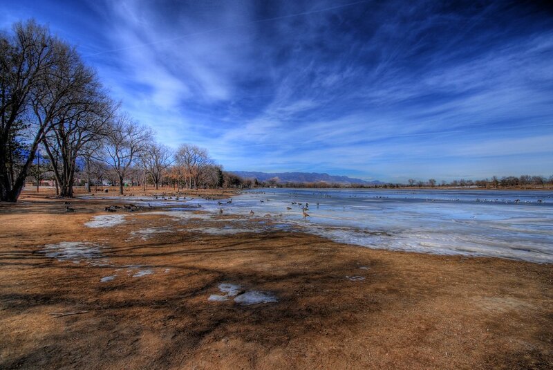 Frozen lake with birds and mountains
