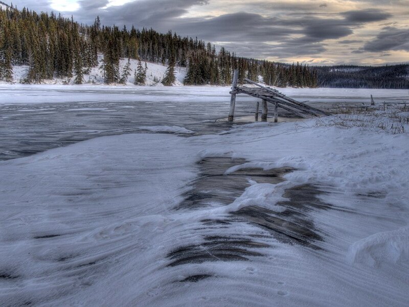 Frozen lake with broken dock
