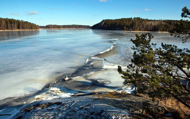 Frozen Lake with Ice Cracks — Blue, Serene, Winter, Photograph, Trees, Rock