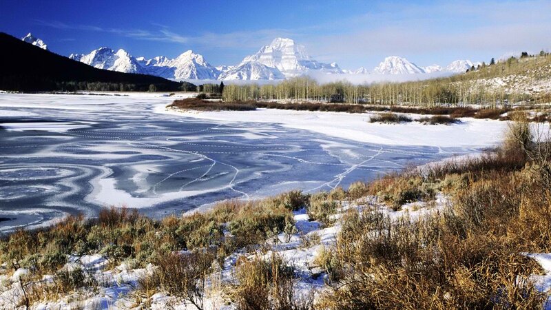 frozen lake with mountain backdrop