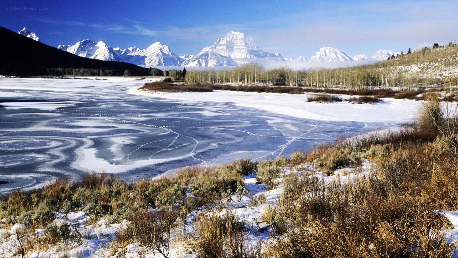frozen lake with mountain backdrop