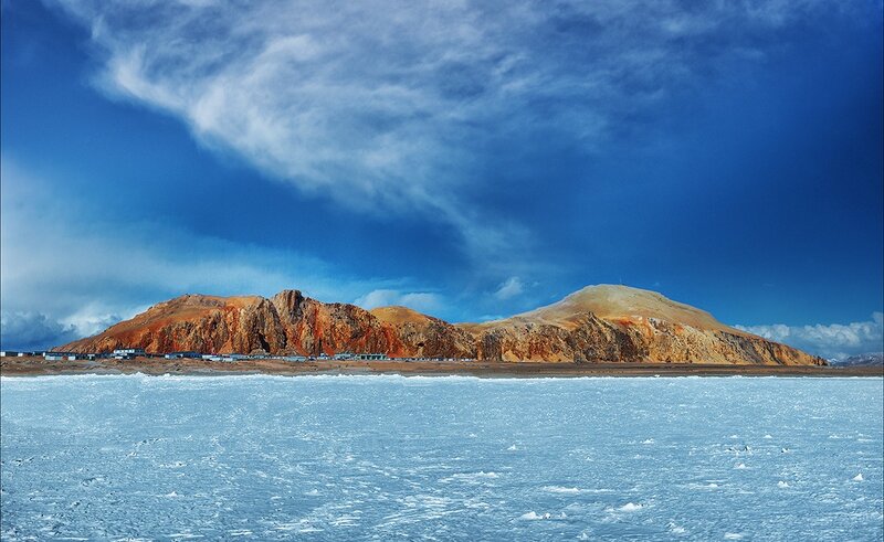 Frozen lake with mountain backdrop