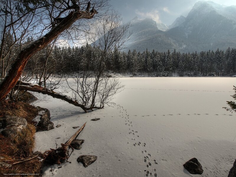 Frozen lake with mountain backdrop