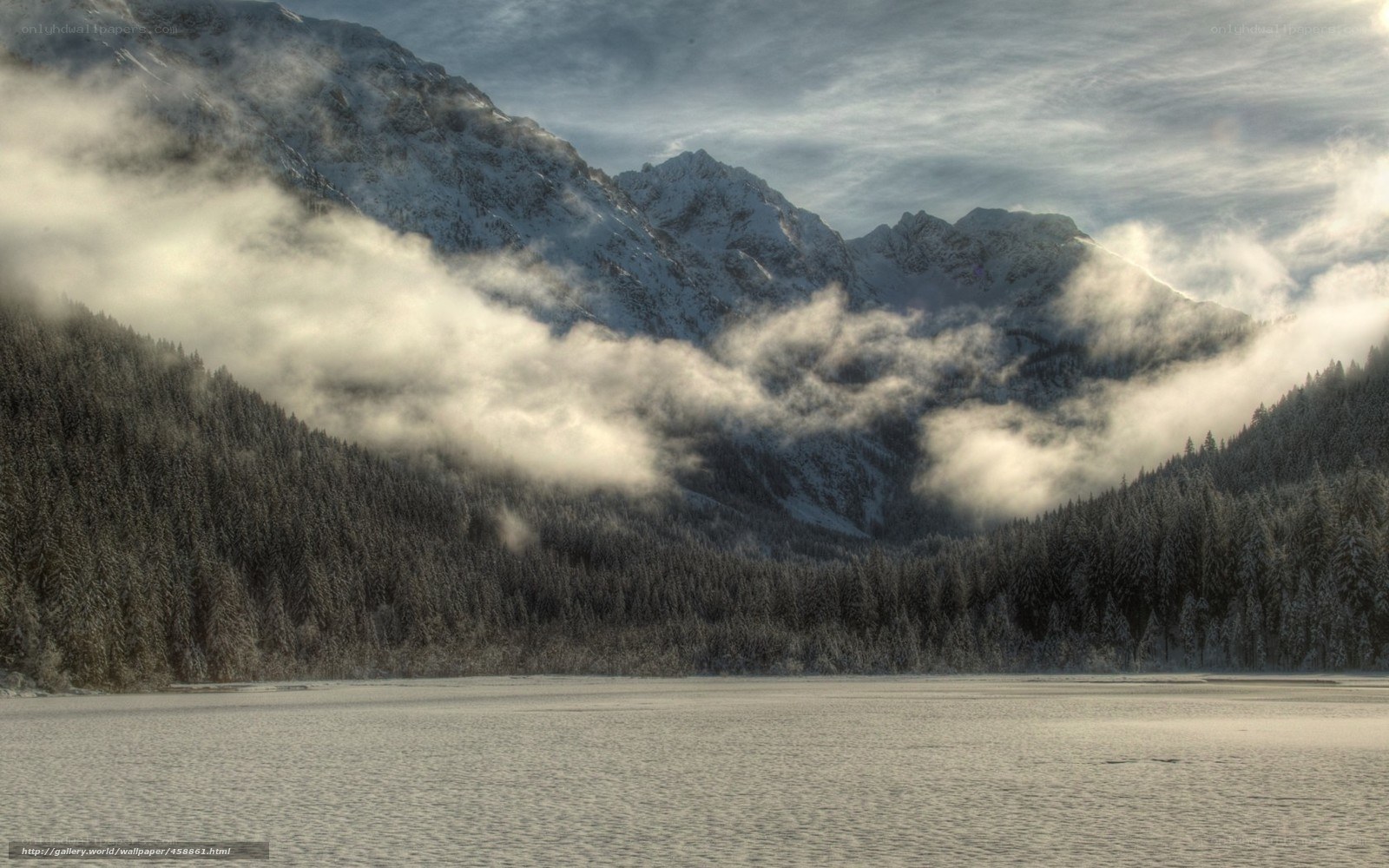 frozen lake with mountain mist