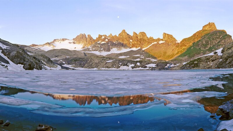 Frozen lake with mountain reflection