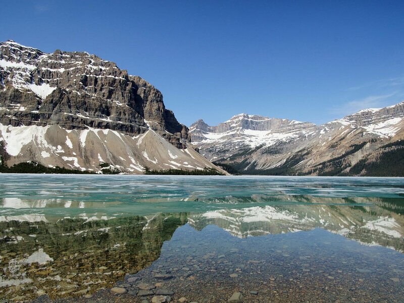 frozen lake with mountain reflection