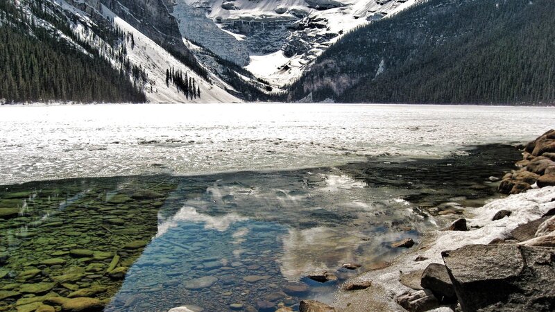 frozen lake with mountain reflection