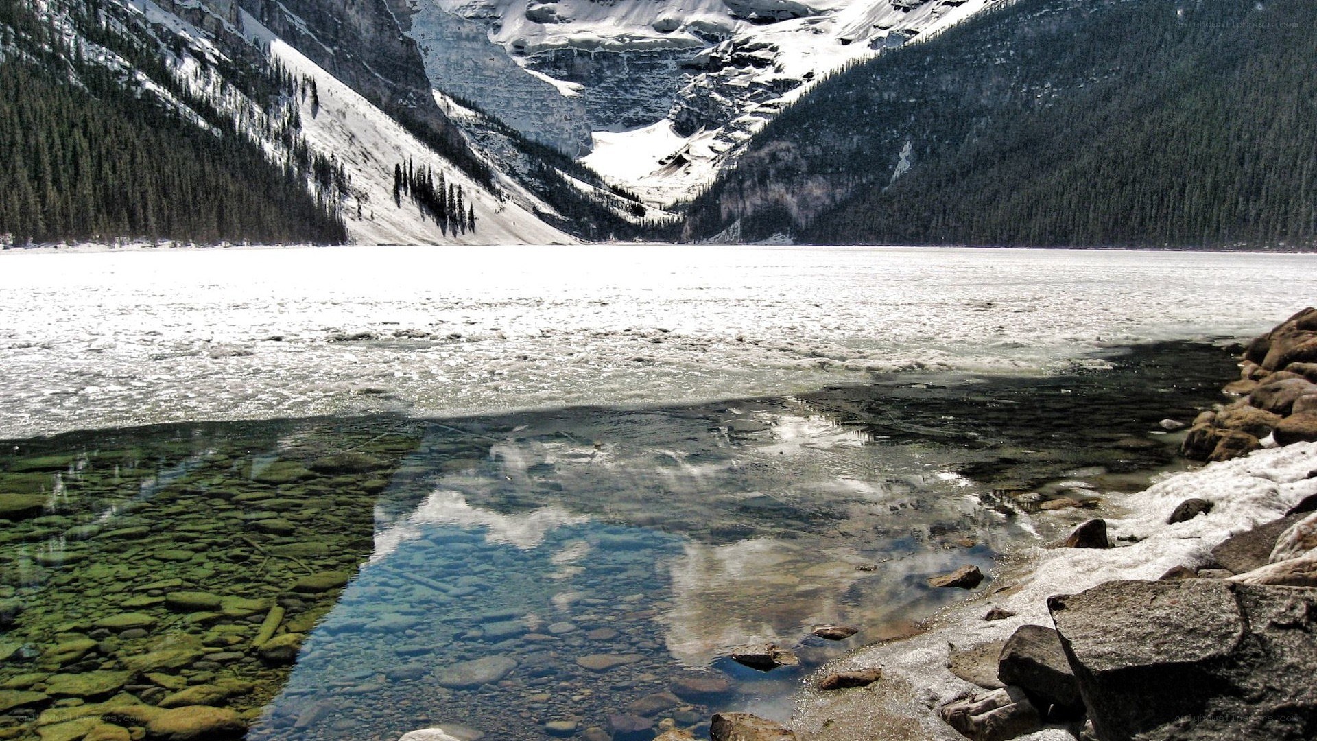 frozen lake with mountain reflection