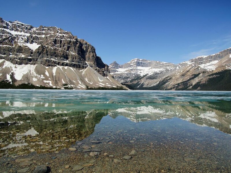 frozen lake with mountain reflection