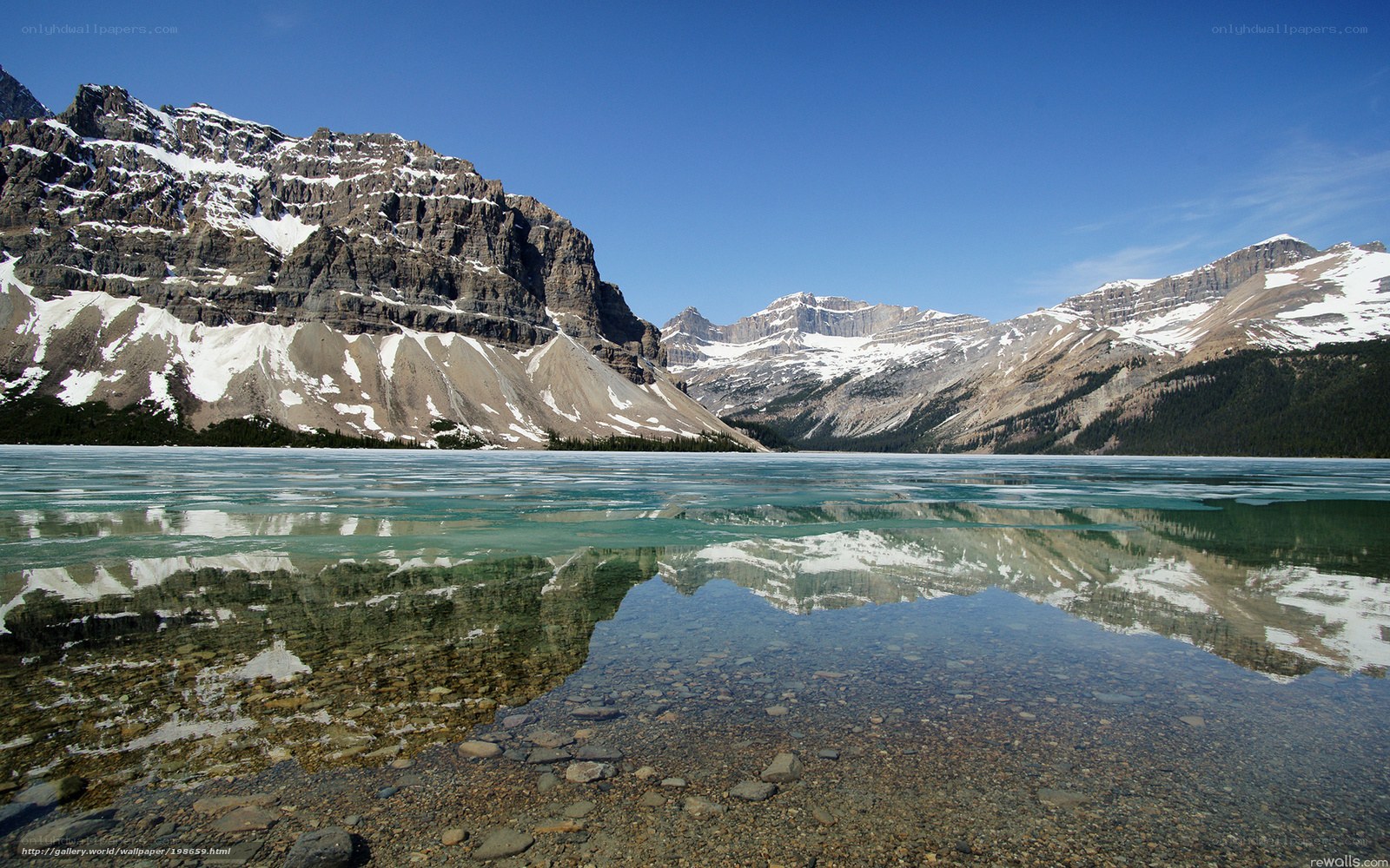 frozen lake with mountain reflection