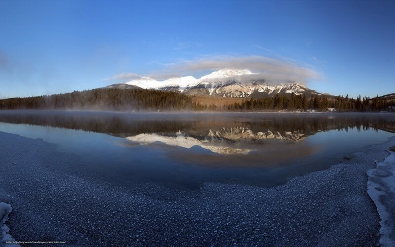 frozen lake with mountain reflection