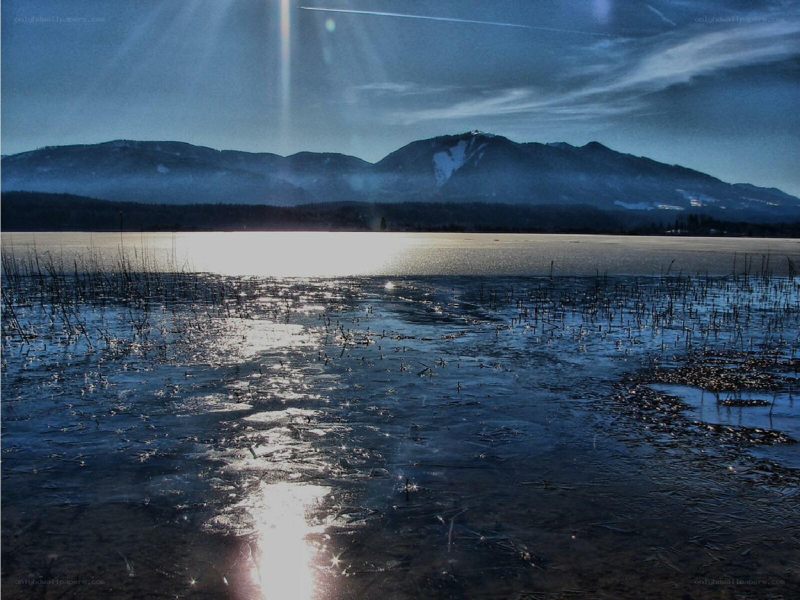 frozen lake with mountains