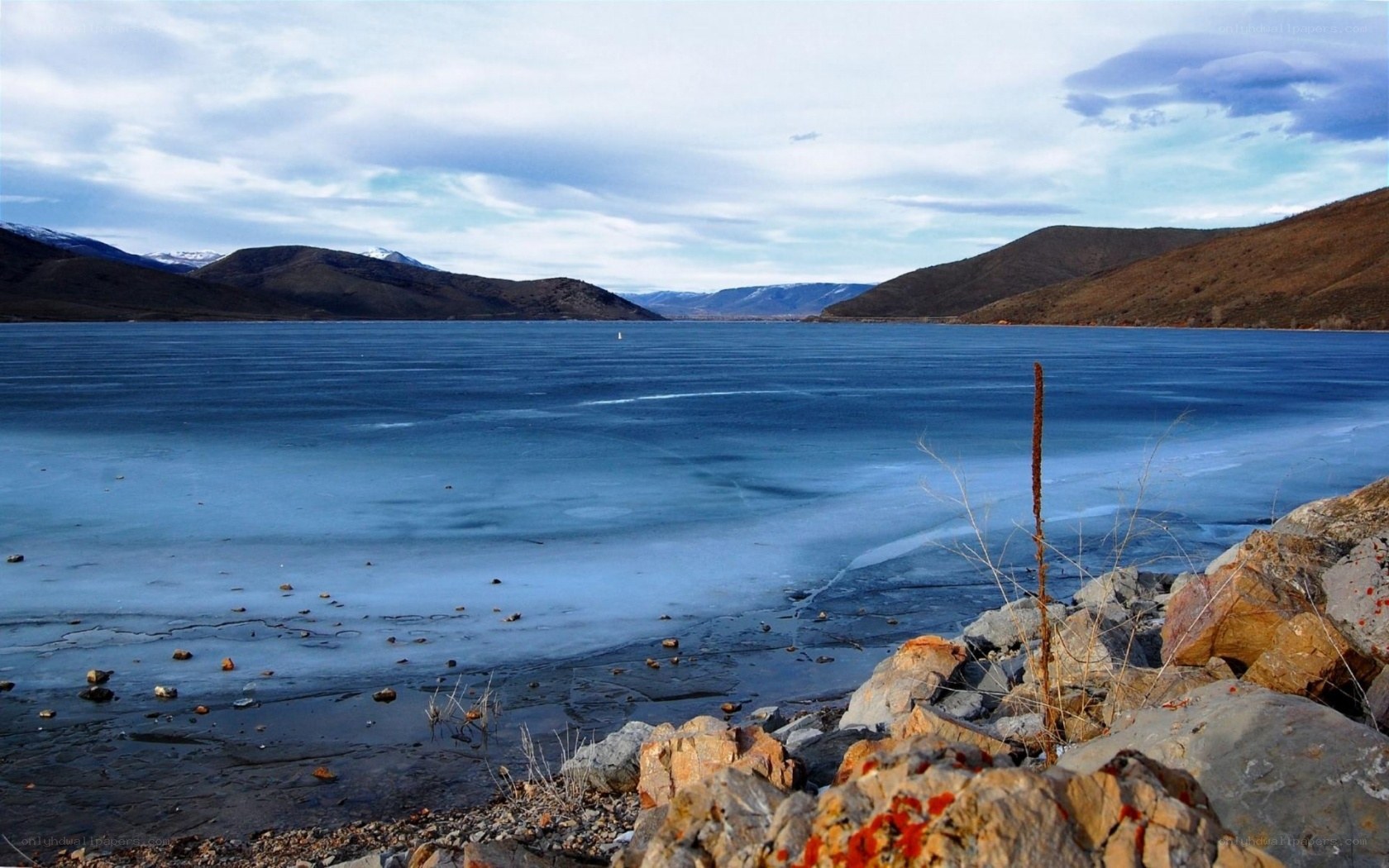 frozen lake with mountains