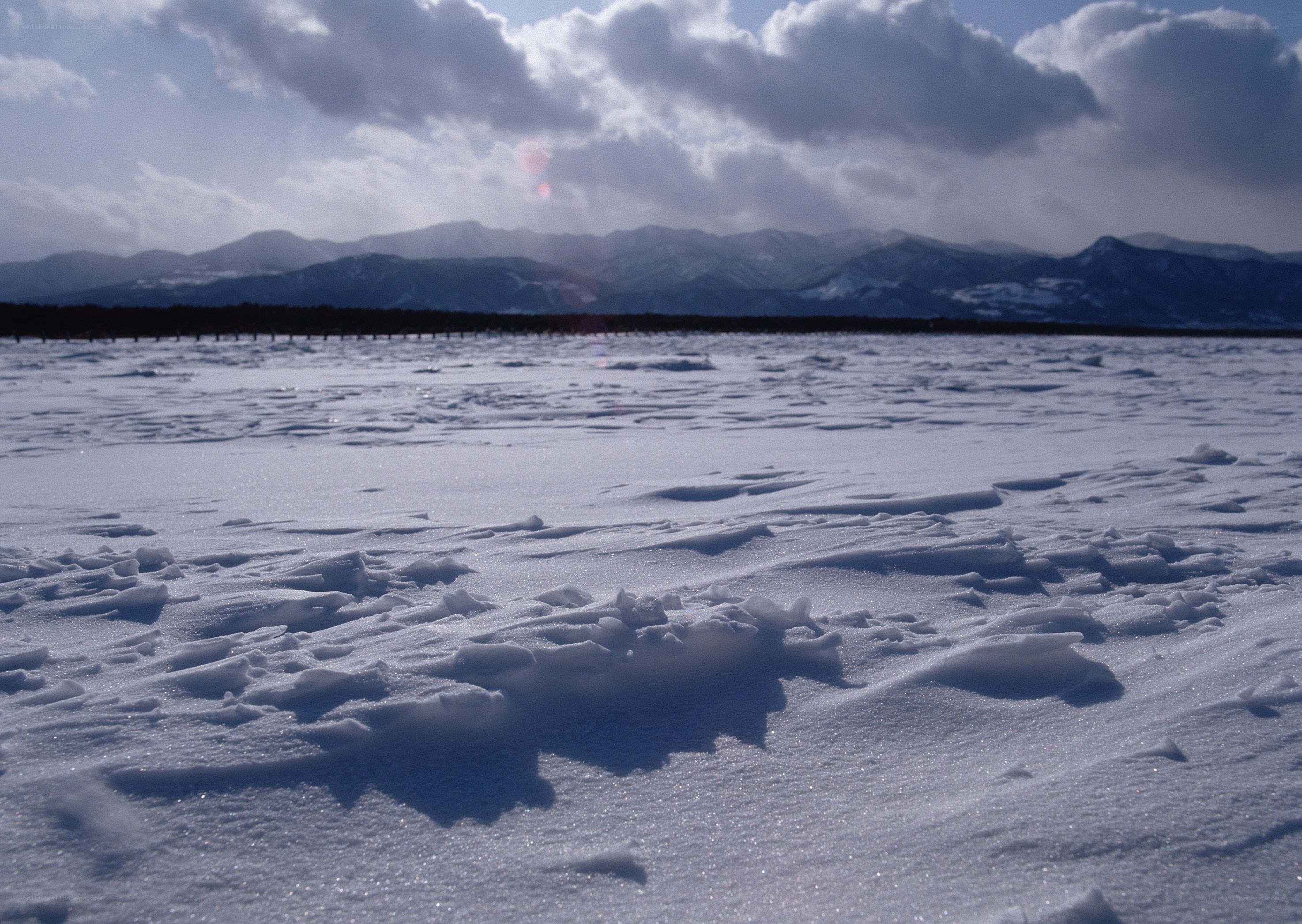 frozen lake with mountains