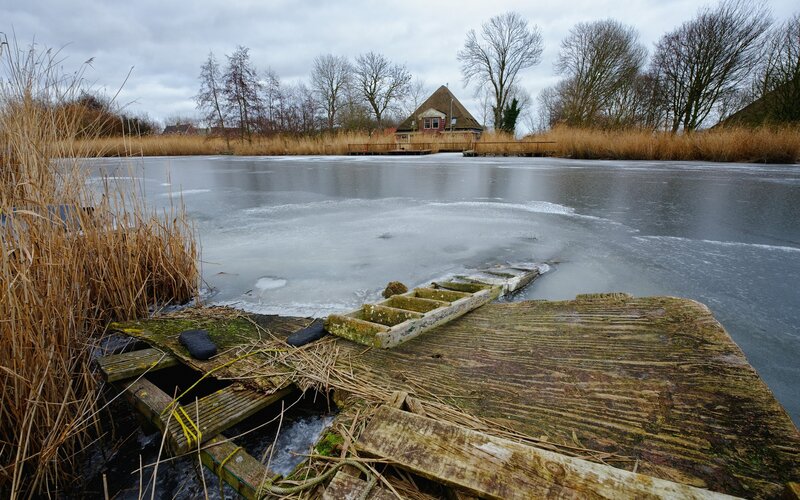 Frozen lake with old dock