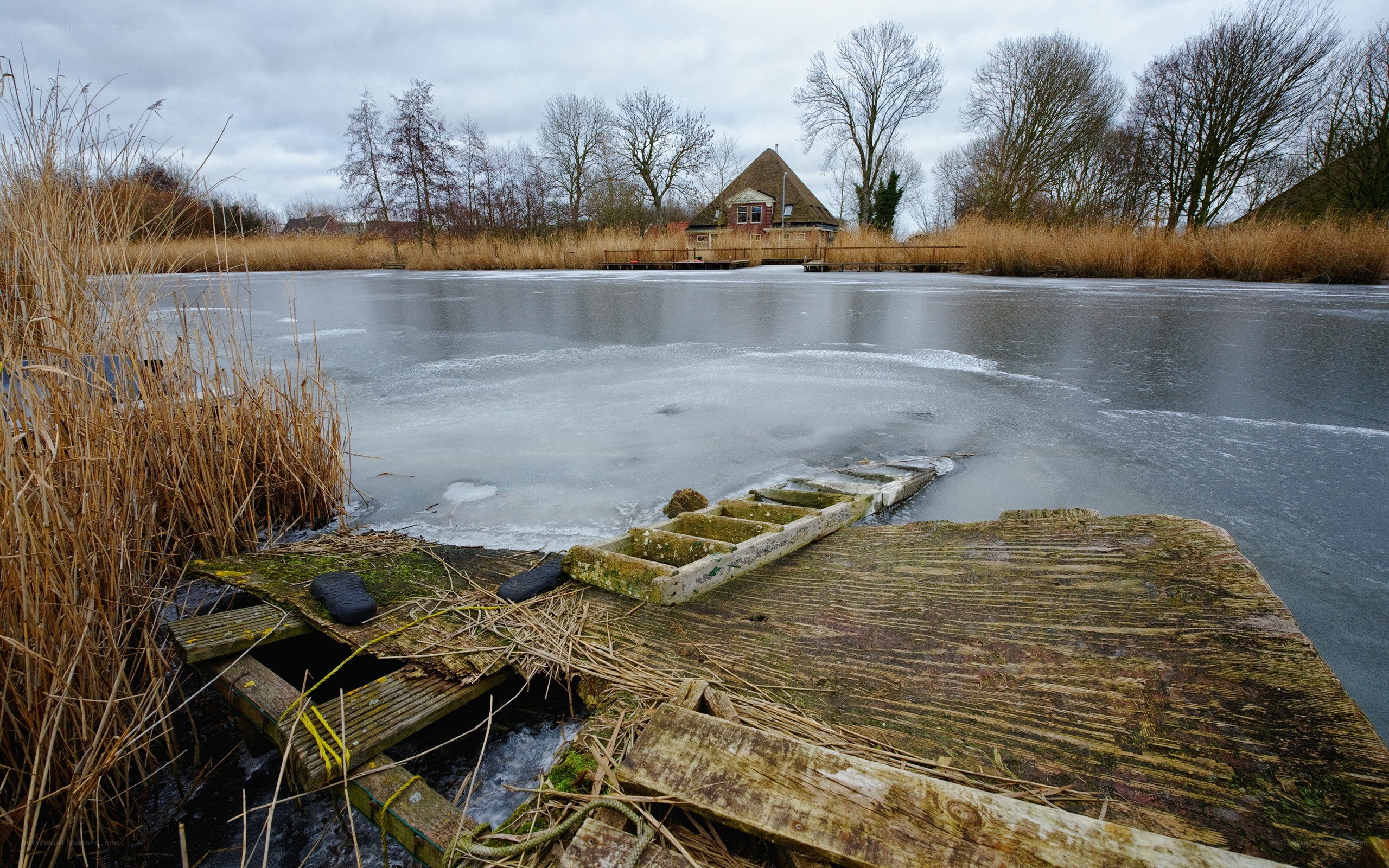 Frozen lake with old dock