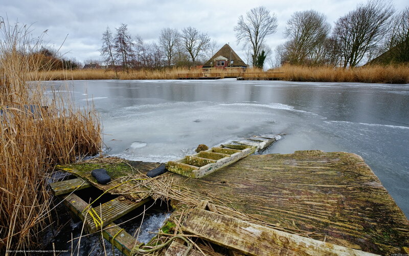 Frozen lake with old dock