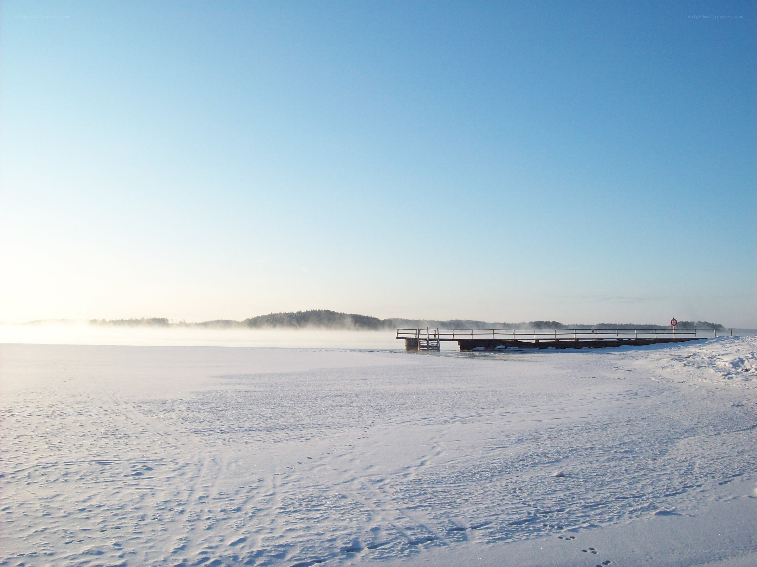 Frozen lake with pier