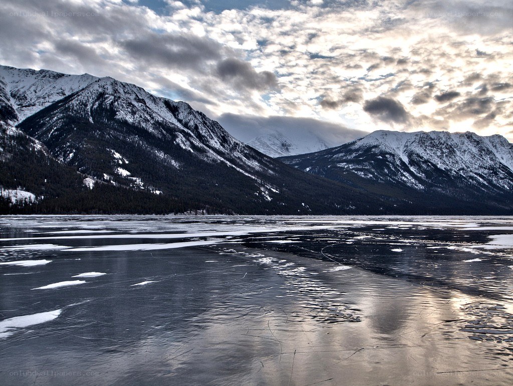 frozen lake with snow-capped mountains