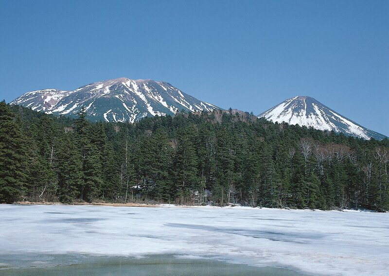 frozen lake with snow-capped mountains