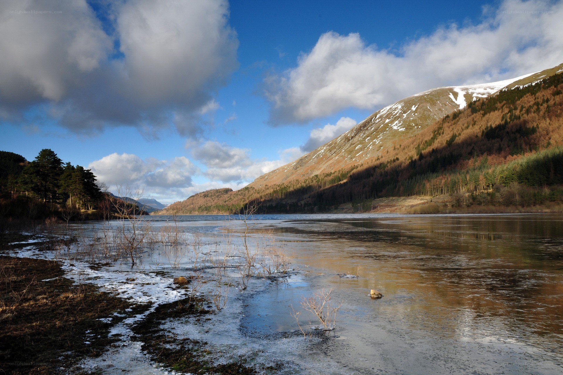 frozen lake with snow-capped mountains