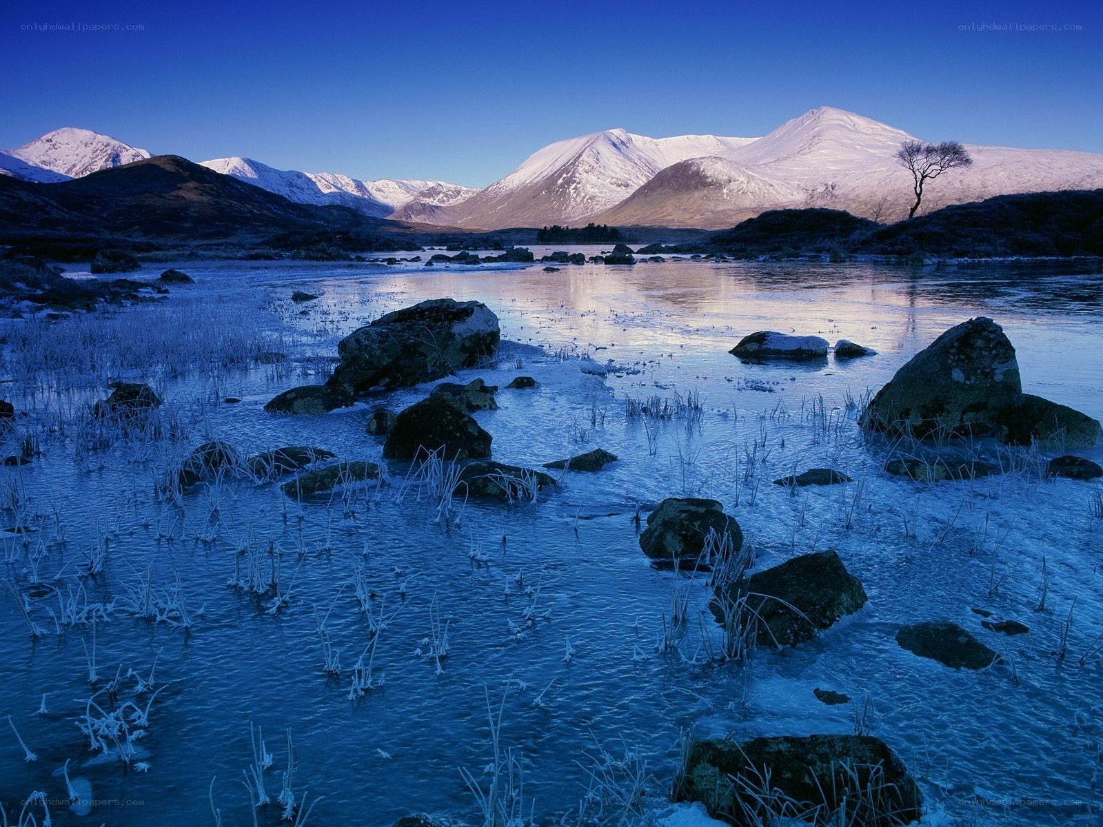 frozen lake with snow-capped mountains