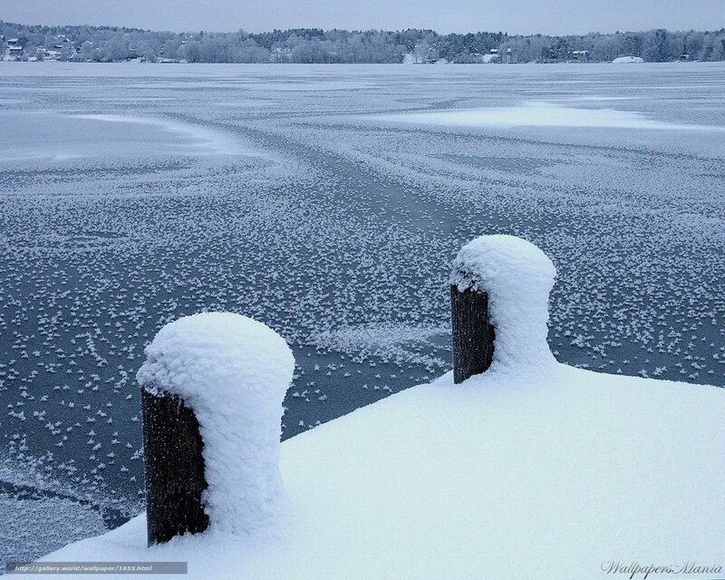 Frozen lake with snow-covered dock