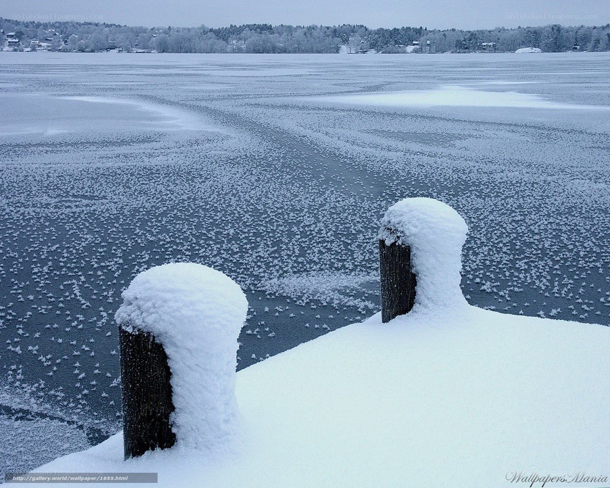 Frozen lake with snow-covered dock