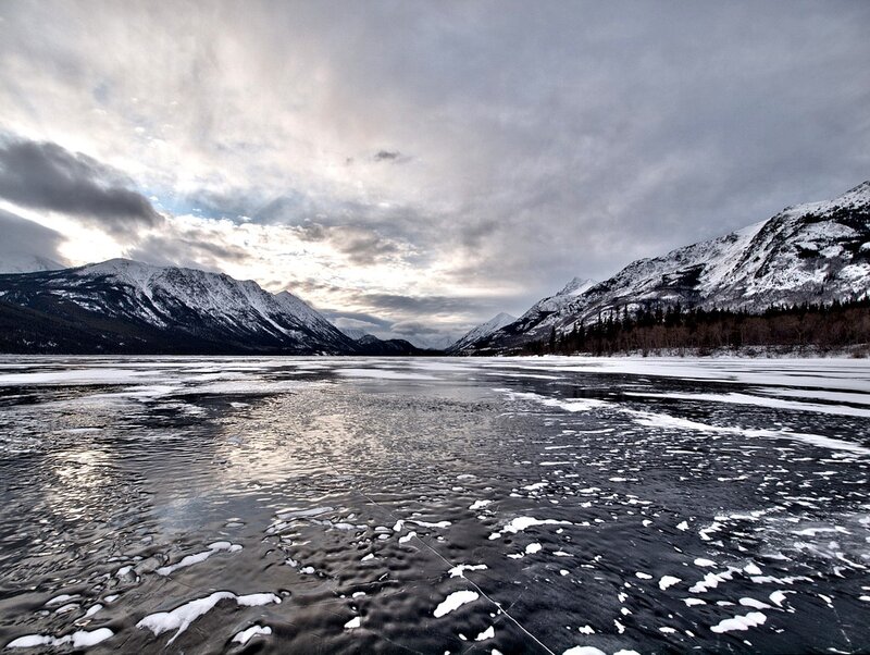 frozen lake with snow-covered mountains