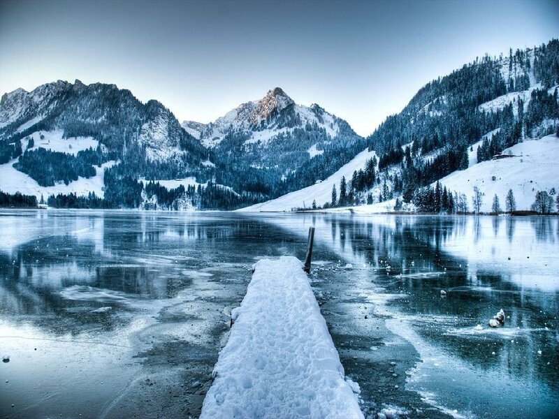 frozen lake with snow-covered mountains