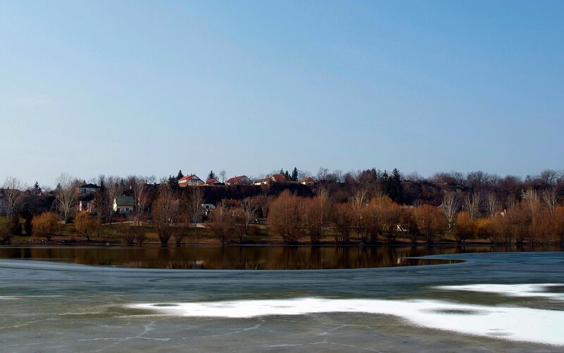 Frozen lake with village view