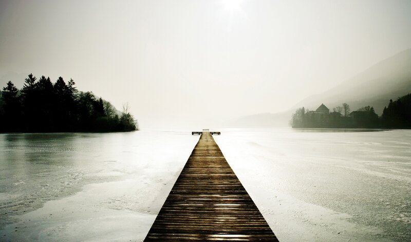 frozen lake with wooden pier