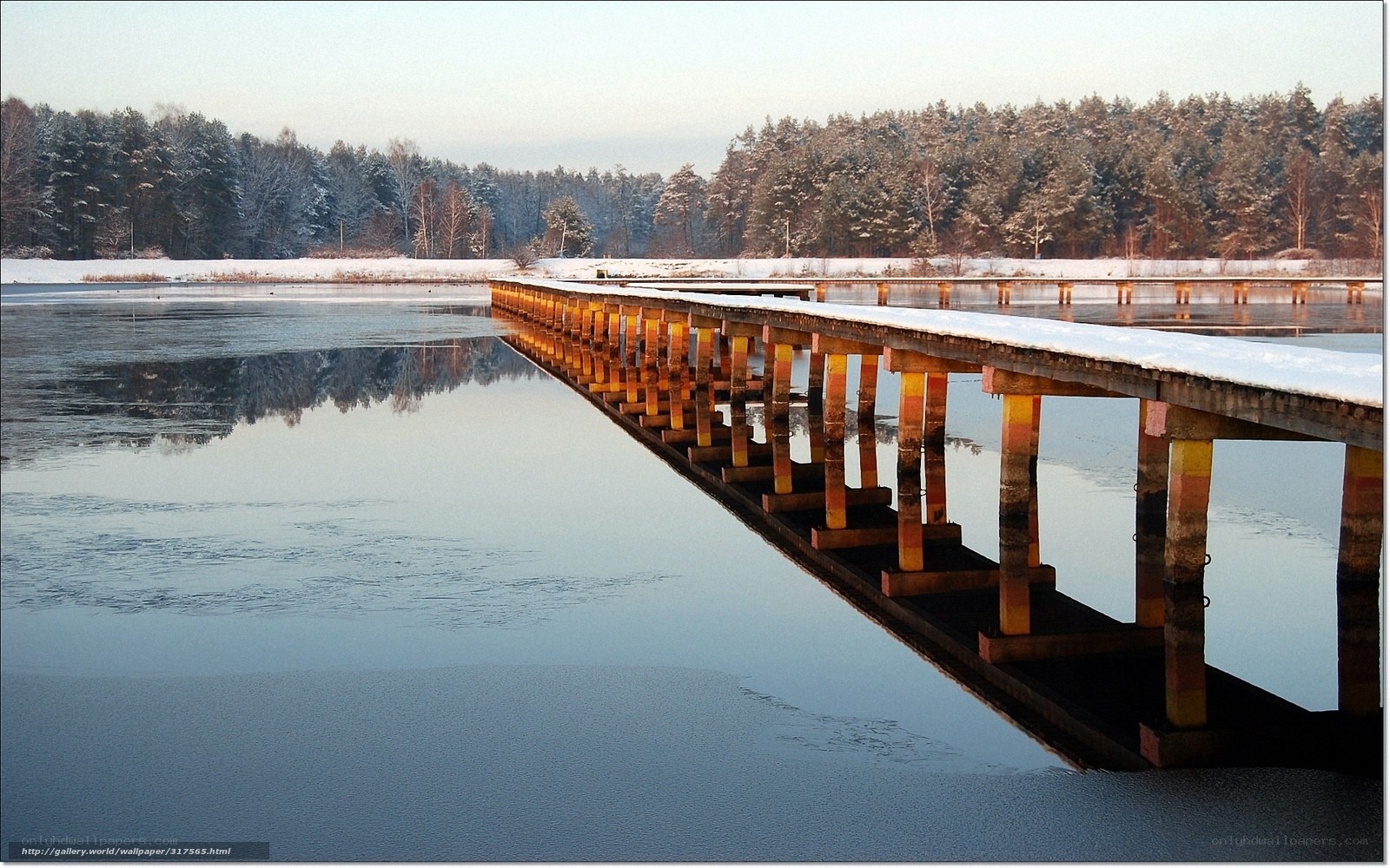 Frozen lake with wooden pier