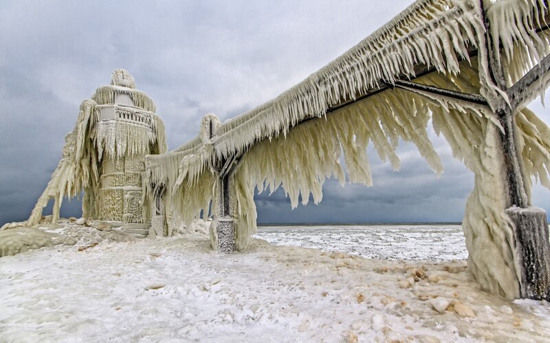 Frozen lighthouse and pier