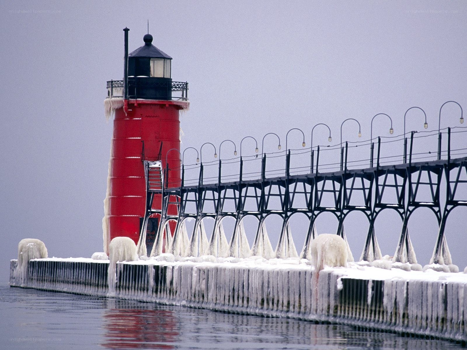 Frozen lighthouse on a pier