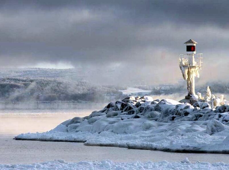 Frozen lighthouse on a rocky shore