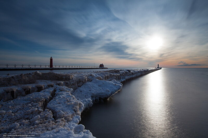 Frozen lighthouse pier at sunset