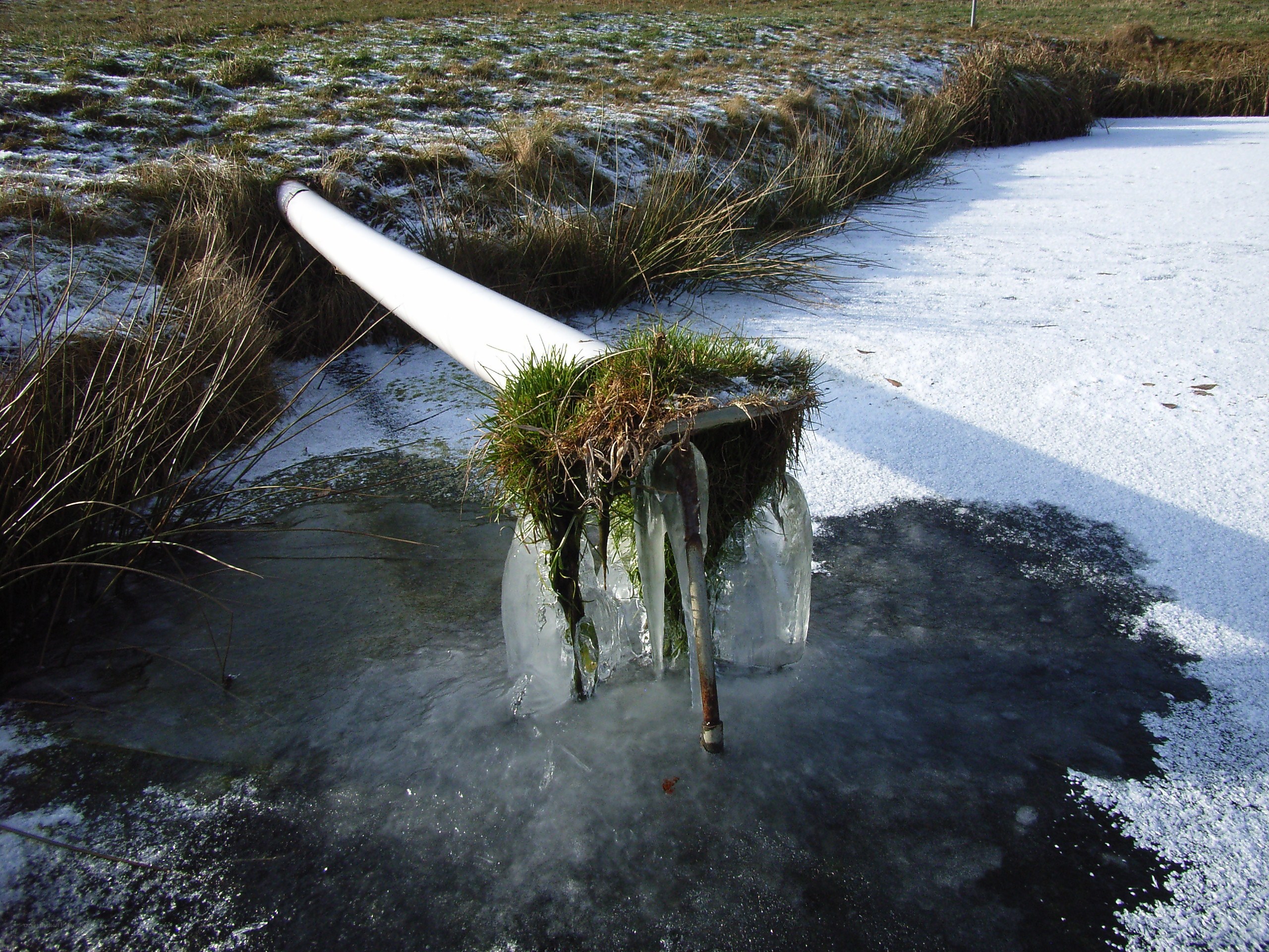 Frozen pipe in a snowy field