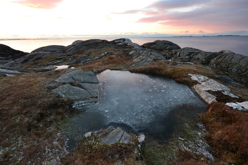 Frozen Pond on Rocky Shore