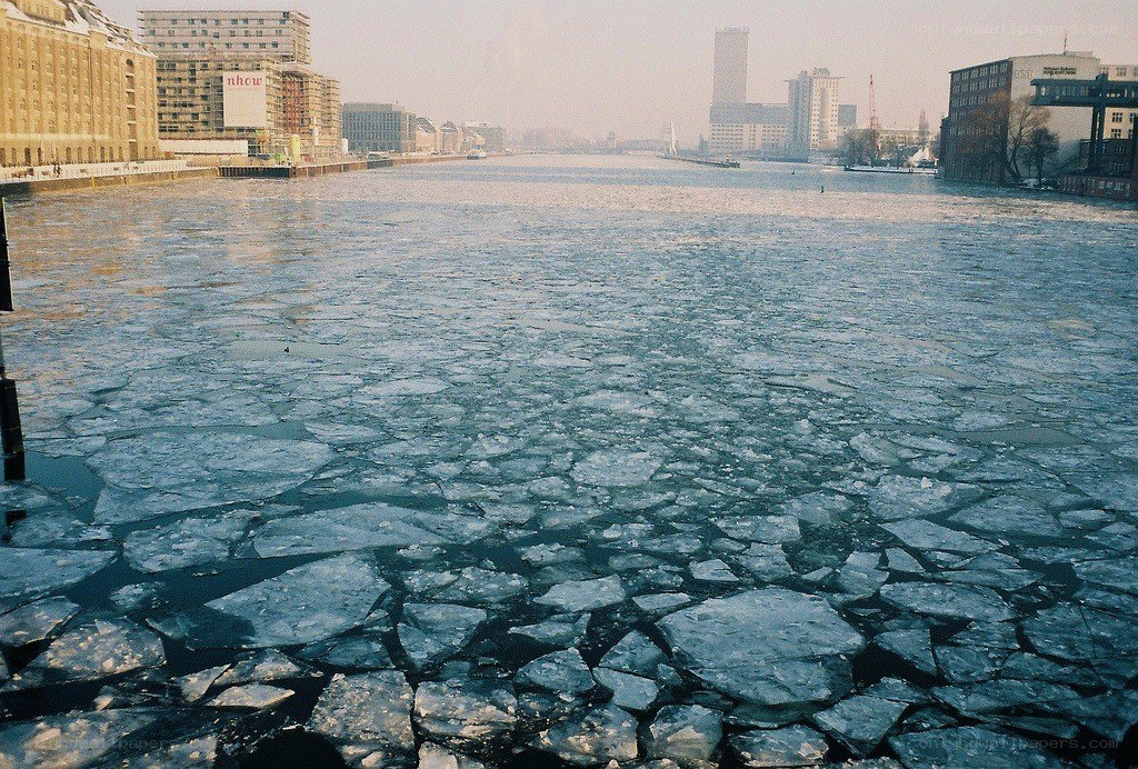 Frozen river in city