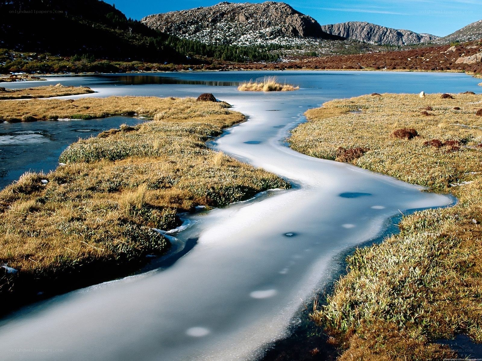 Frozen river in mountain landscape