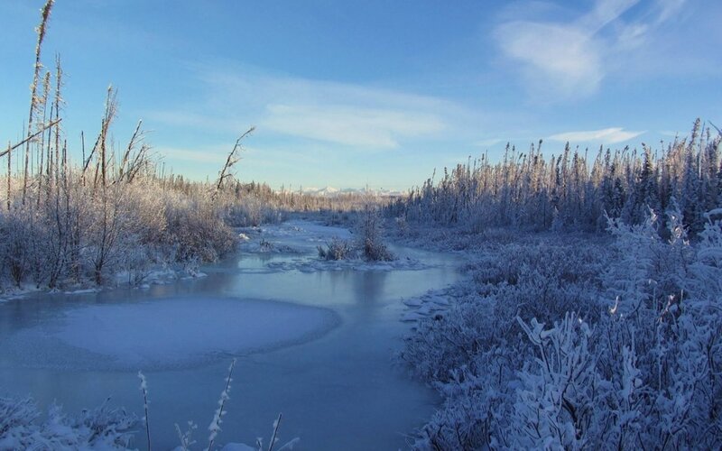 frozen river in snowy landscape