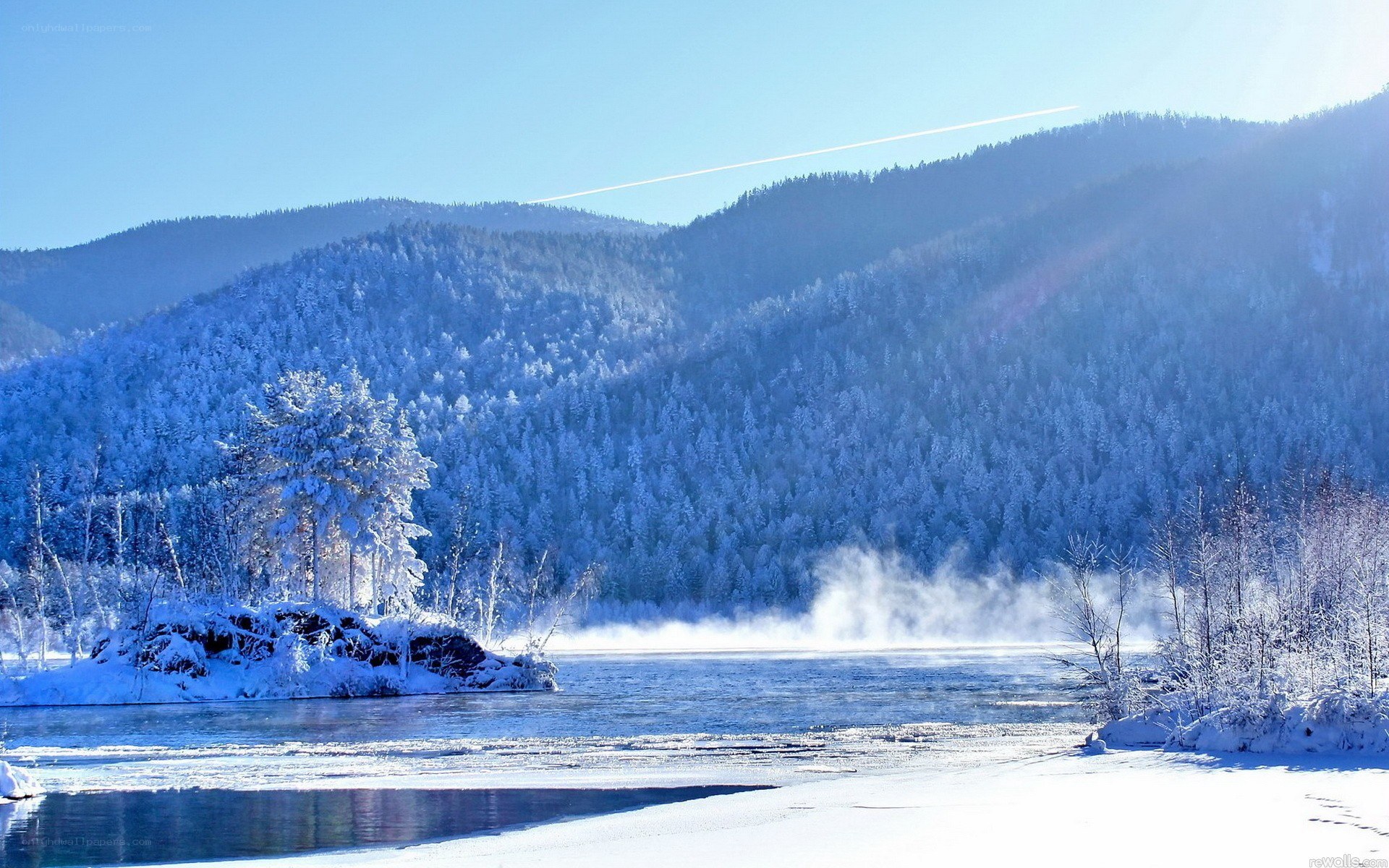 frozen river in snowy mountains