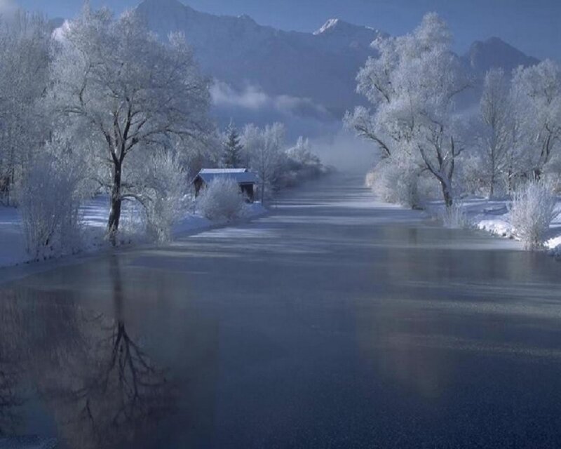 Frozen River in Winter — Blue, Serene, Photograph, Snow-covered Trees, Mountains, Small Cabin